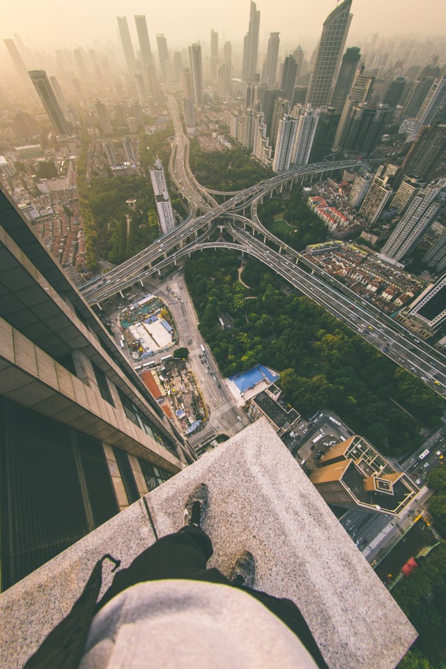 Shanghai skyline viewed from the edge of a rooftop.